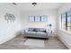 Bright sitting room with gray sofa, wood-look floors, and large windows at 1169 Castle Pines Ct, Reunion, FL 34747
