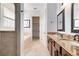 Elegant bathroom with double sinks, granite counters, and a soaking tub at 1169 Castle Pines Ct, Reunion, FL 34747