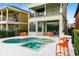 Relaxing kidney-shaped pool and spa with plenty of seating for guests at 1169 Castle Pines Ct, Reunion, FL 34747