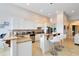 Modern kitchen with white cabinets, granite countertops, and stainless steel appliances at 1169 Castle Pines Ct, Reunion, FL 34747