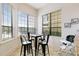 Cozy breakfast nook with four chairs and large windows at 1169 Castle Pines Ct, Reunion, FL 34747
