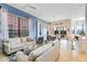 Open living room with comfortable sofas, a large window, and access to the dining area at 1169 Castle Pines Ct, Reunion, FL 34747