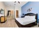 Main bedroom with king-size bed and access to the hallway and bathroom at 1169 Castle Pines Ct, Reunion, FL 34747