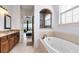 Spa-like bathroom with soaking tub, double vanity, and walk-in shower at 1169 Castle Pines Ct, Reunion, FL 34747