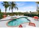 Relaxing kidney-shaped pool with a spa and plenty of lounge chairs at 1169 Castle Pines Ct, Reunion, FL 34747