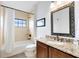 Clean bathroom with single sink, granite countertop, and a shower/tub combo at 1169 Castle Pines Ct, Reunion, FL 34747