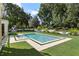 Relaxing backyard featuring a clean-lined pool and beautifully manicured lawn at 5121 Latrobe Dr, Windermere, FL 34786