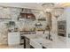 Spacious kitchen boasts a statement range hood, stone backsplash, and custom cabinetry at 5121 Latrobe Dr, Windermere, FL 34786