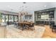 Modern dining room with live-edge table, adjacent wine room, and access to patio at 5121 Latrobe Dr, Windermere, FL 34786