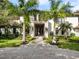 Elegant two-story home with palm trees and a brick driveway at 5121 Latrobe Dr, Windermere, FL 34786