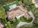 Bird's-eye view of a house with a tile roof, pool, and lush landscaping at 5121 Latrobe Dr, Windermere, FL 34786
