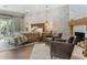 Elegant main bedroom with a stone accent wall, plush bedding, and ample natural light at 5121 Latrobe Dr, Windermere, FL 34786