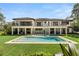 Resort-style backyard with a large pool and expansive lawn, perfect for entertaining at 5121 Latrobe Dr, Windermere, FL 34786