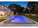 Night view of the pool with surrounding landscape at 5121 Latrobe Dr, Windermere, FL 34786