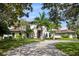 Two story luxury home with palm trees and circular driveway at 5121 Latrobe Dr, Windermere, FL 34786