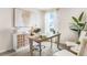 Bright home office features a large desk, built-in shelving, and plenty of natural light at 2563 Sage Valley Way, Winter Haven, FL 33884