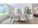 Bright dining room with a large table and chairs, and kitchen view at 2563 Sage Valley Way, Winter Haven, FL 33884