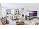Open concept living room and kitchen with modern appliances and neutral decor at 2563 Sage Valley Way, Winter Haven, FL 33884
