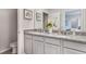 Double vanity bathroom with granite countertops and a large shower at 2563 Sage Valley Way, Winter Haven, FL 33884