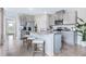Modern kitchen with gray cabinets, granite counters, and stainless steel appliances at 2563 Sage Valley Way, Winter Haven, FL 33884