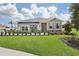 One-story home with gray siding, brown accents, and a two-car garage at 5945 Cliffbow Loop, Leesburg, FL 34748