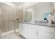 Bathroom with double vanity, granite countertops, and shower at 5945 Cliffbow Loop, Leesburg, FL 34748