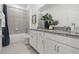 Bathroom with double vanity, granite countertops, and bathtub at 5945 Cliffbow Loop, Leesburg, FL 34748