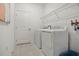 Laundry room with washer, dryer, and overhead shelving at 5945 Cliffbow Loop, Leesburg, FL 34748
