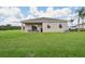House exterior and large backyard with grassy area at 5945 Cliffbow Loop, Leesburg, FL 34748