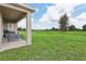 Spacious backyard with lush lawn and tranquil pond views at 5945 Cliffbow Loop, Leesburg, FL 34748