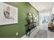 Green accent wall entryway, modern console table, and mirror at 5945 Cliffbow Loop, Leesburg, FL 34748