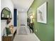 Bright entryway with green accent wall and stylish decor at 5945 Cliffbow Loop, Leesburg, FL 34748