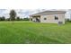 Spacious backyard with grassy area and home exterior view at 5945 Cliffbow Loop, Leesburg, FL 34748