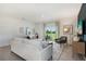 Spacious living room with white sofa and access to backyard at 5945 Cliffbow Loop, Leesburg, FL 34748