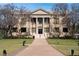 City Hall building with a classic design, columns, and landscaping at 5945 Cliffbow Loop, Leesburg, FL 34748