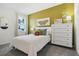 Bright bedroom with a queen-size bed, dresser, and window at 5945 Cliffbow Loop, Leesburg, FL 34748