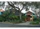 Brightly colored waterfront restaurant with lush landscaping at 5945 Cliffbow Loop, Leesburg, FL 34748