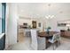 Open concept dining room with a wooden table and kitchen views at 5945 Cliffbow Loop, Leesburg, FL 34748