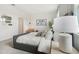 Main bedroom with gray upholstered bed and sitting area at 5945 Cliffbow Loop, Leesburg, FL 34748