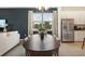 Spacious dining room with a large table and kitchen access at 5945 Cliffbow Loop, Leesburg, FL 34748