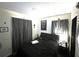 Bedroom with a black leather bed frame and gray curtains at 1051 E Patrick Cir, Daytona Beach, FL 32117