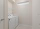 Bright laundry room with side-by-side washer and dryer at 3369 Lilac Way, Davenport, FL 33897