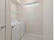 Bright laundry room with side-by-side washer and dryer at 3369 Lilac Way, Davenport, FL 33897