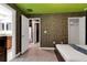 Bedroom with brick feature wall and access to bathroom at 1406 Moon Valley Dr, Davenport, FL 33896