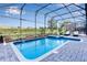 Inviting screened-in pool and spa with patio area at 1406 Moon Valley Dr, Davenport, FL 33896