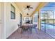 Covered patio with table and chairs, adjacent to pool area at 1406 Moon Valley Dr, Davenport, FL 33896
