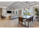 Open concept dining room with a large table and access to pool at 1406 Moon Valley Dr, Davenport, FL 33896