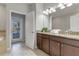 Double vanity, granite countertops, and access to a private patio at 1406 Moon Valley Dr, Davenport, FL 33896