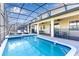 Large screened pool and spa with covered patio and outdoor seating at 1406 Moon Valley Dr, Davenport, FL 33896