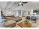 Open concept living and dining area with large sectional sofa and modern light fixtures at 1406 Moon Valley Dr, Davenport, FL 33896